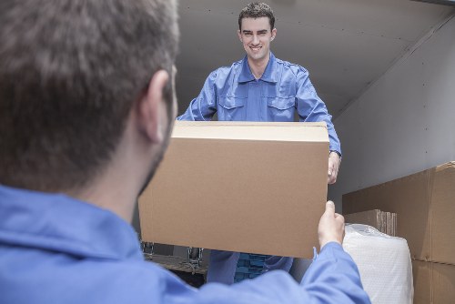 Removal van workers loading furniture in a responsible logistics setting