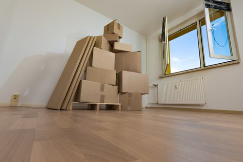 Removal team handling furniture in a Dulwich flat with narrow access