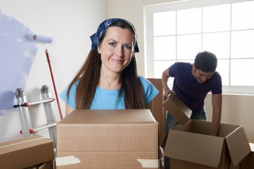 Furniture and boxes being unloaded from a removal van at a Dulwich property